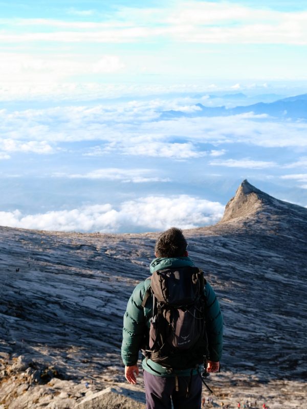 rear-view-woman-standing-mountain-against-sky